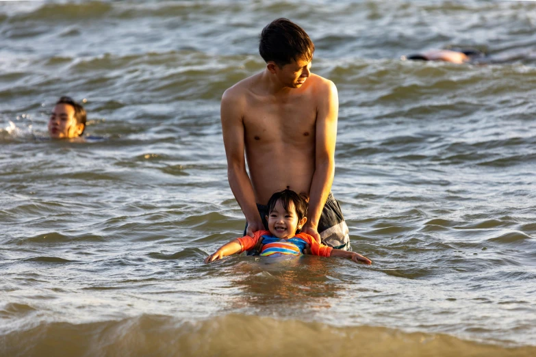 a man and child stand in the water