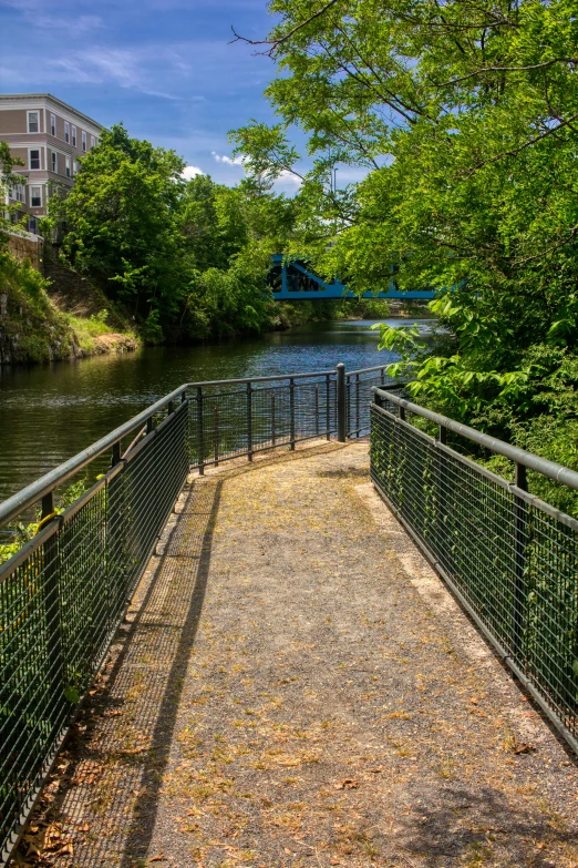 a walkway between two large buildings by water