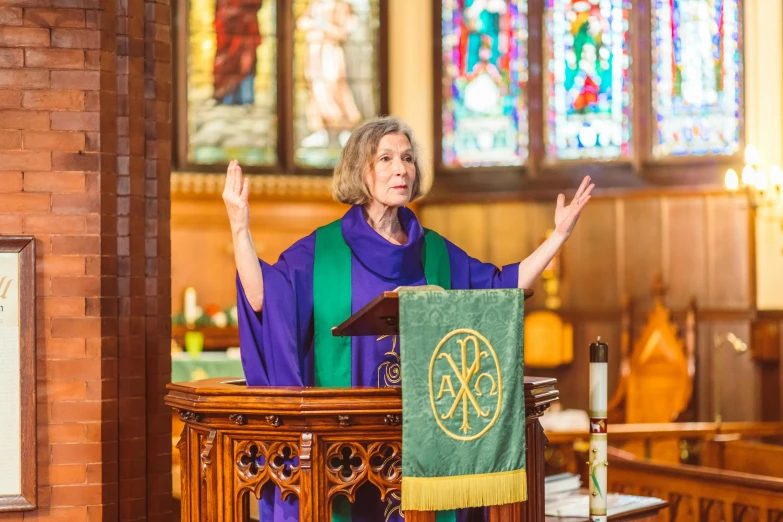 woman speaking on a small pulpit at a church