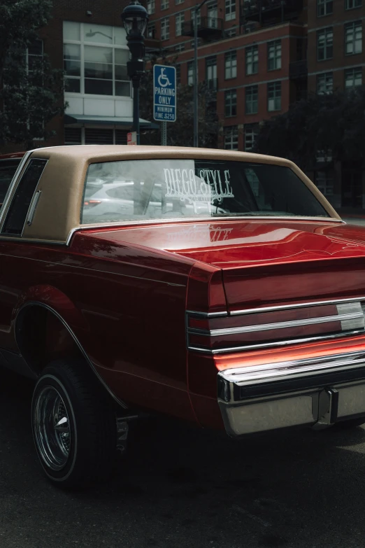 a red vintage car parked in a parking lot