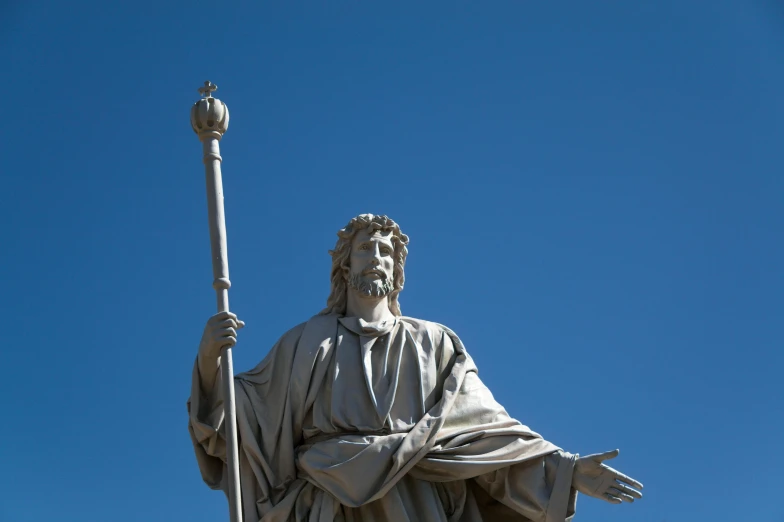 a statue of a man is shown with his hands in the air