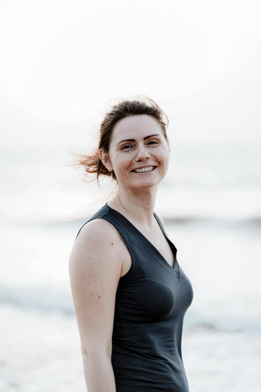 woman in black top standing on the beach