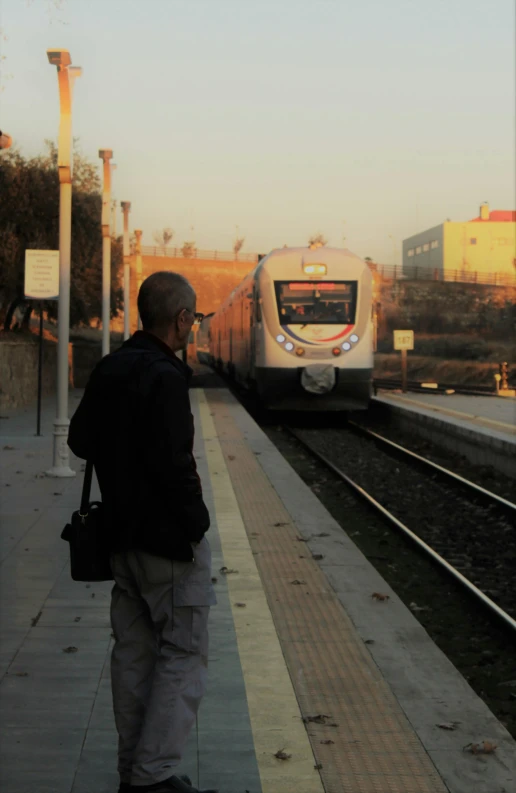 a man walking towards an open train station