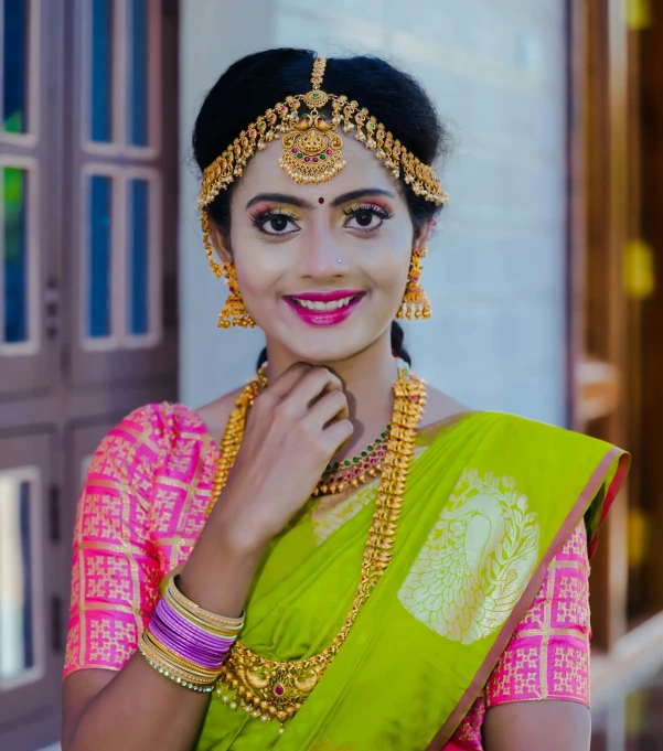 a woman wearing traditional indian garb posing for a po