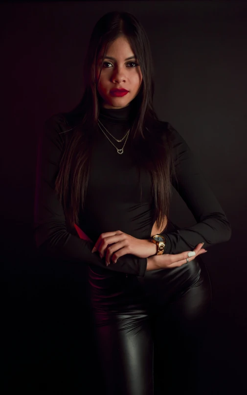 woman with long hair wearing leather pants and black top