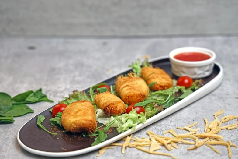 a platter with fried food on it next to dipping sauce