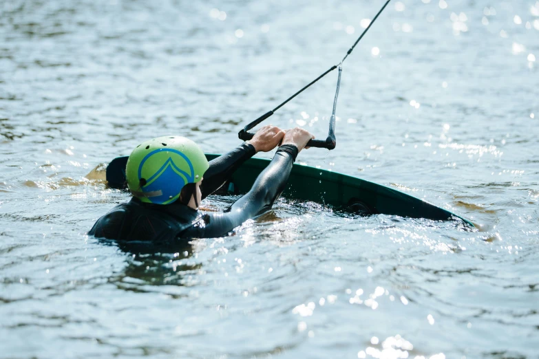 a man holding onto a pole in the water