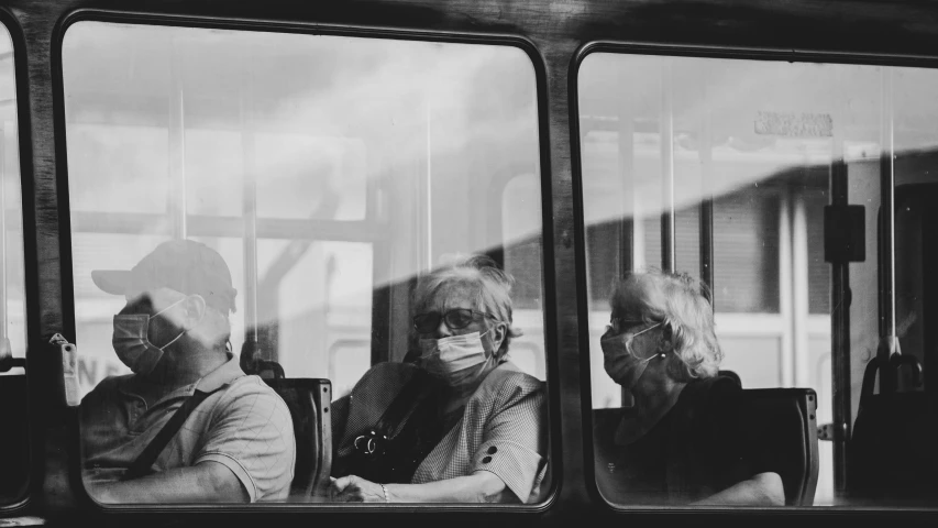 a man and woman sitting on a bus next to each other