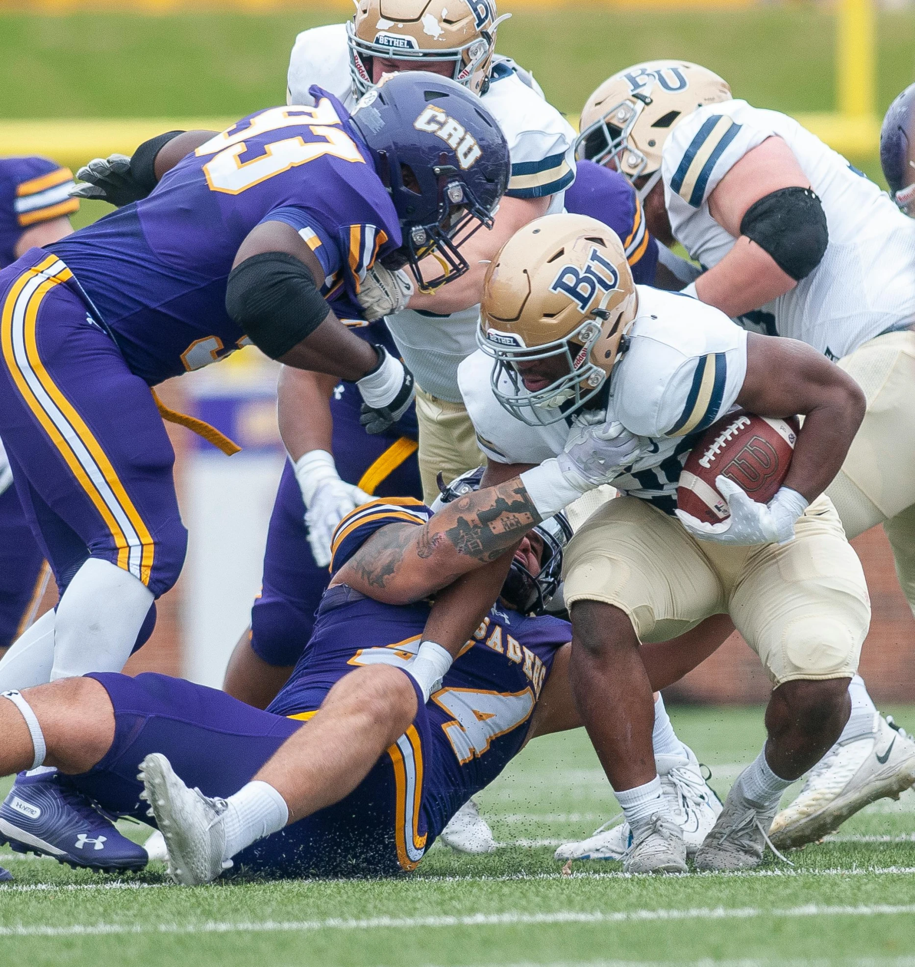 several football players in uniforms playing football