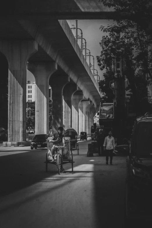 a chair sitting next to a sidewalk under a freeway