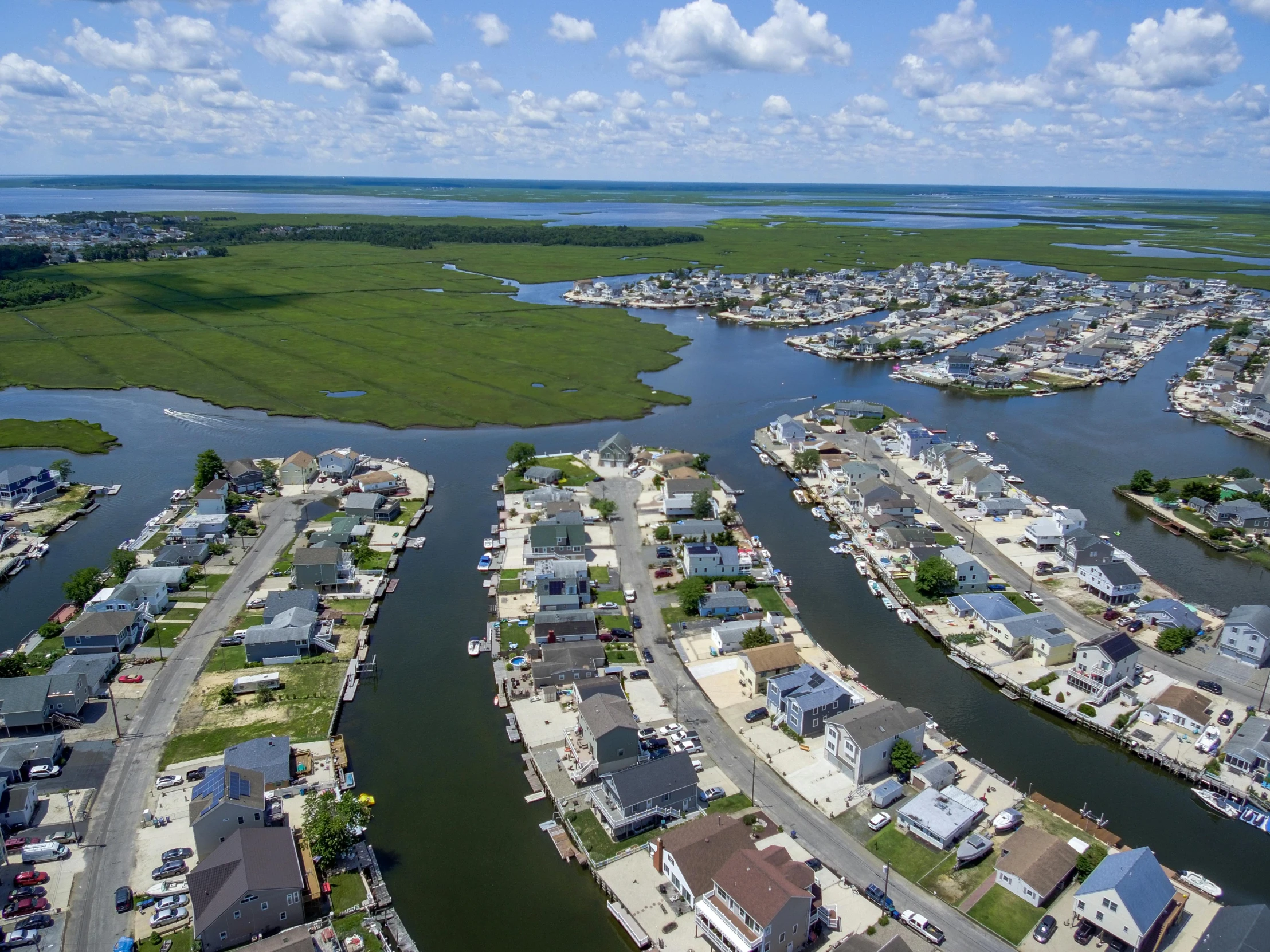 the waterway in front of a city and homes on either side