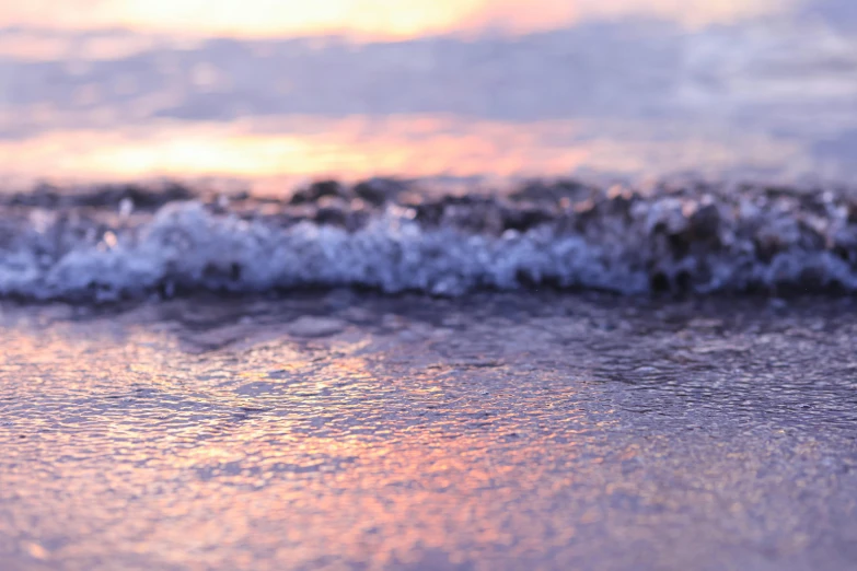 the beach has waves coming in from the sand