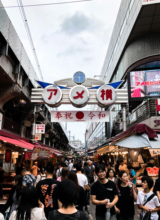 a crowded street that has some signs and other people