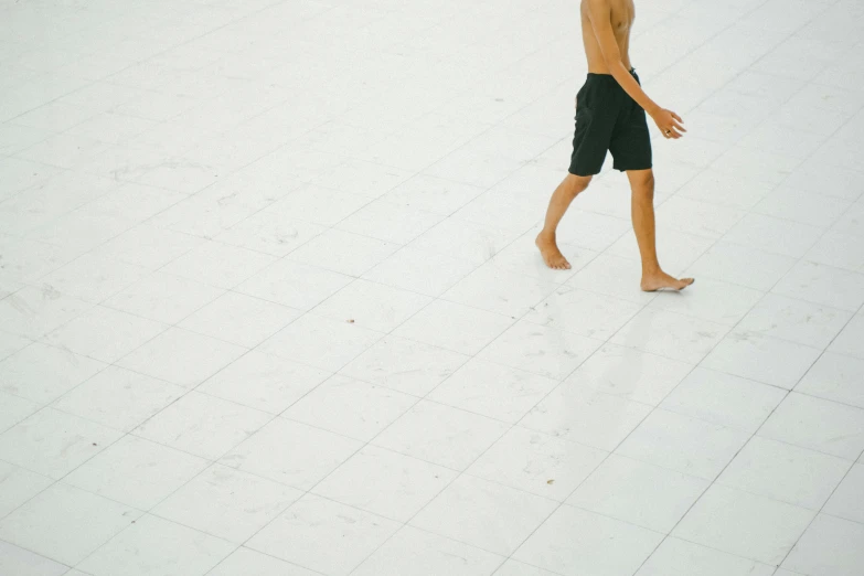 a man walking on the floor holding an umbrella