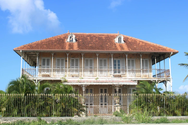 a tall wooden house with balconies on the top