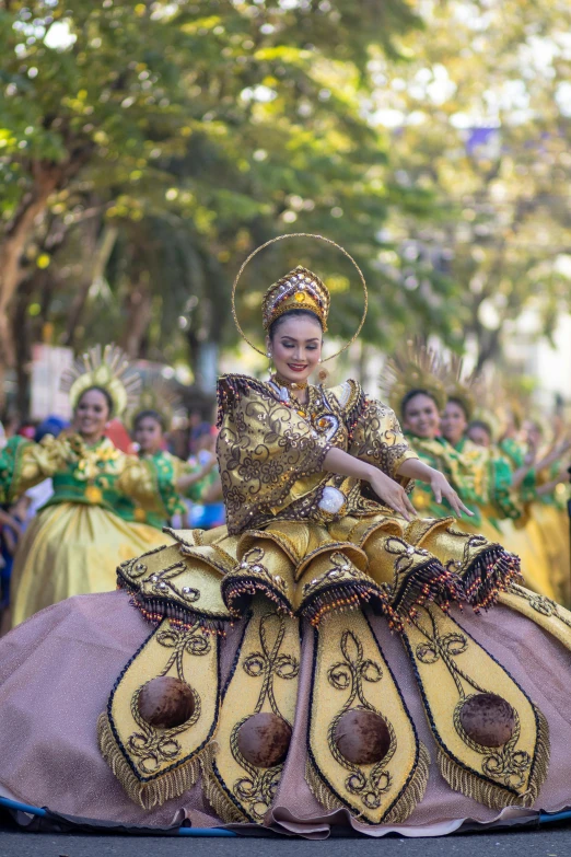 a woman in yellow sitting on a large elephant