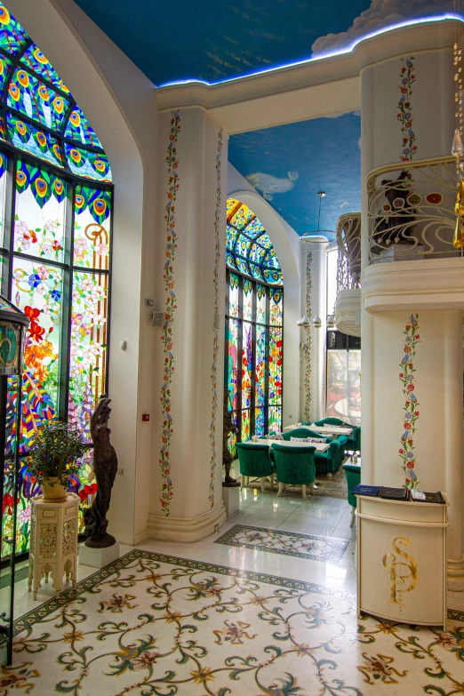 this foyer has a wall with a variety of stained glass windows