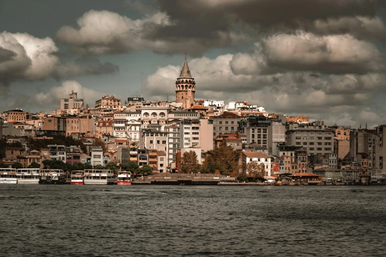 a city view with buildings on the shore and clouds in the sky