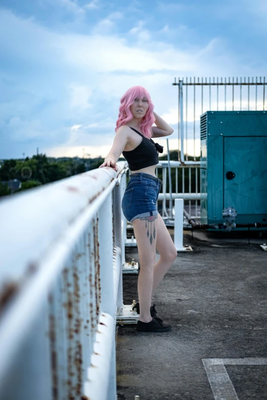 girl in black shirt standing on balcony near fence