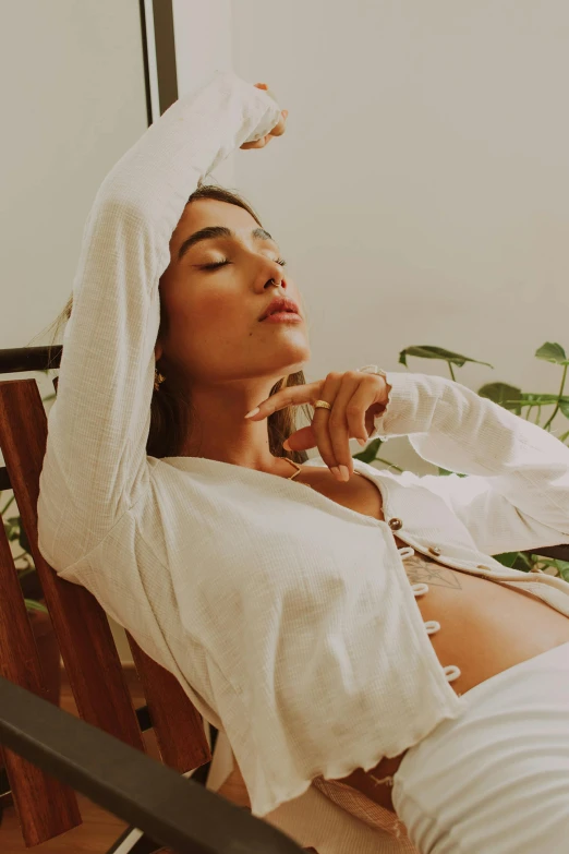 a woman laying on the ground in her bed talking on the phone