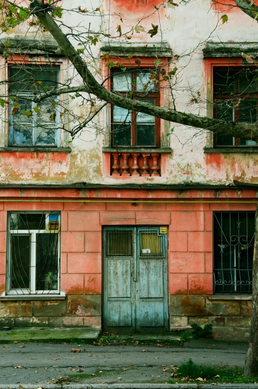 an old building with three balconies and broken windows