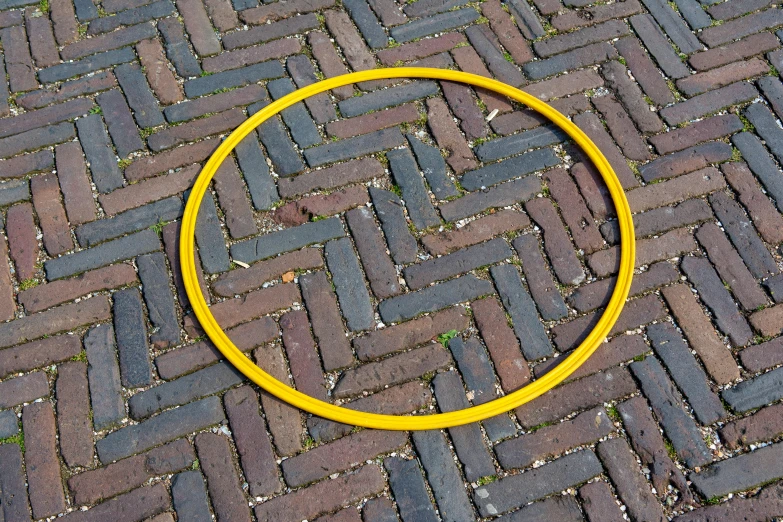 a yellow circle on brick road with a small area