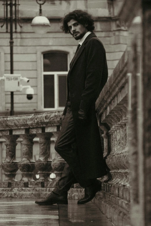 black and white pograph of a man standing on steps