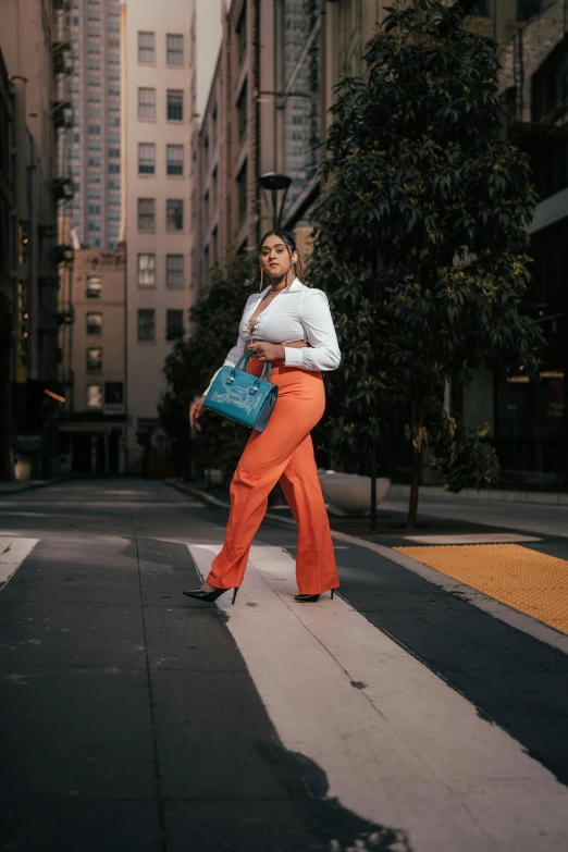 a woman is standing on a street with her back to the camera