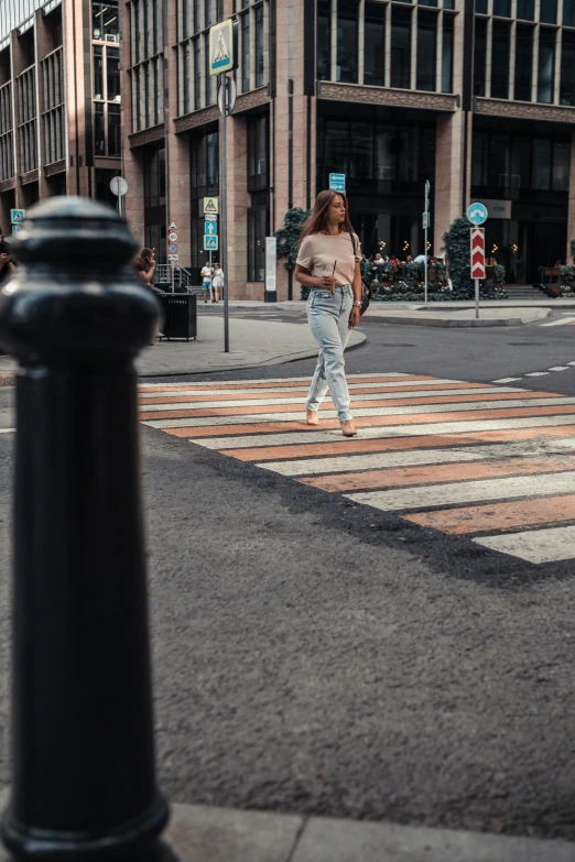 a woman is crossing the street while crossing