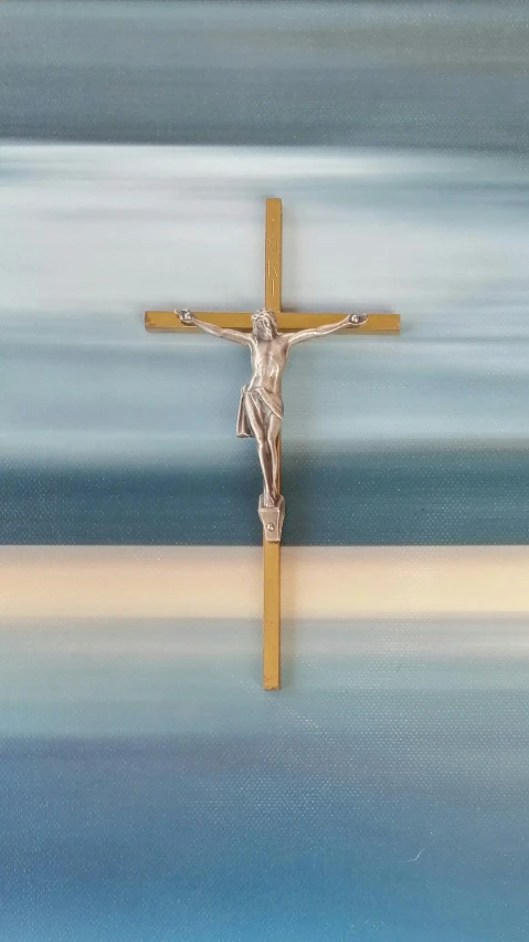 the christ on the cross is placed in front of blue and white water
