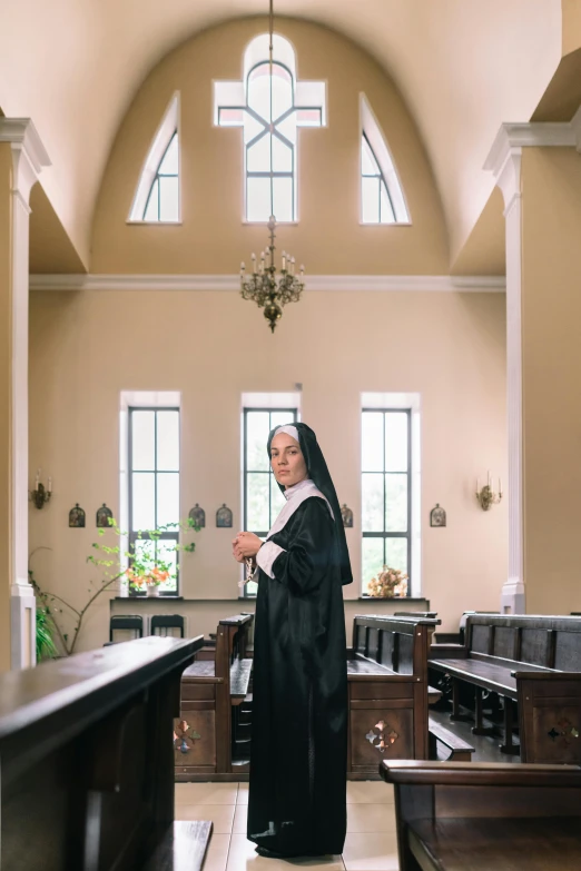 a nun standing in a church, looking ahead