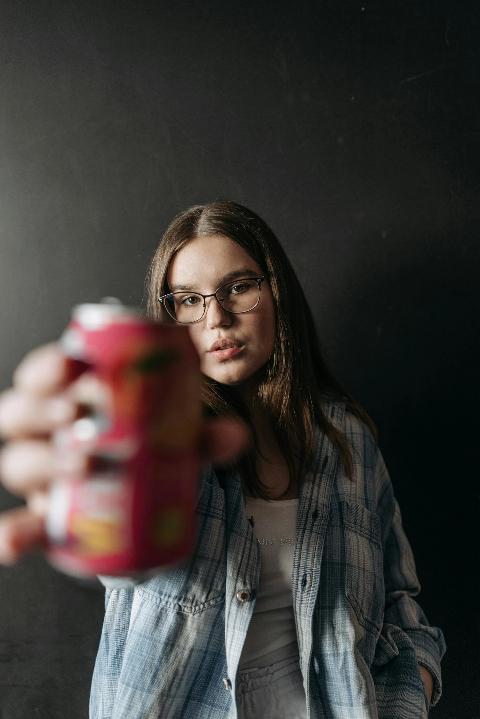the woman is posing for the camera with a can of beer
