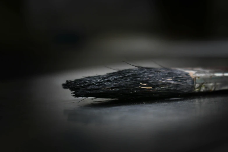 a black brush sitting on top of a table