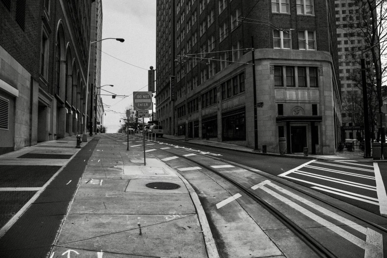 empty street and railroad tracks in a city