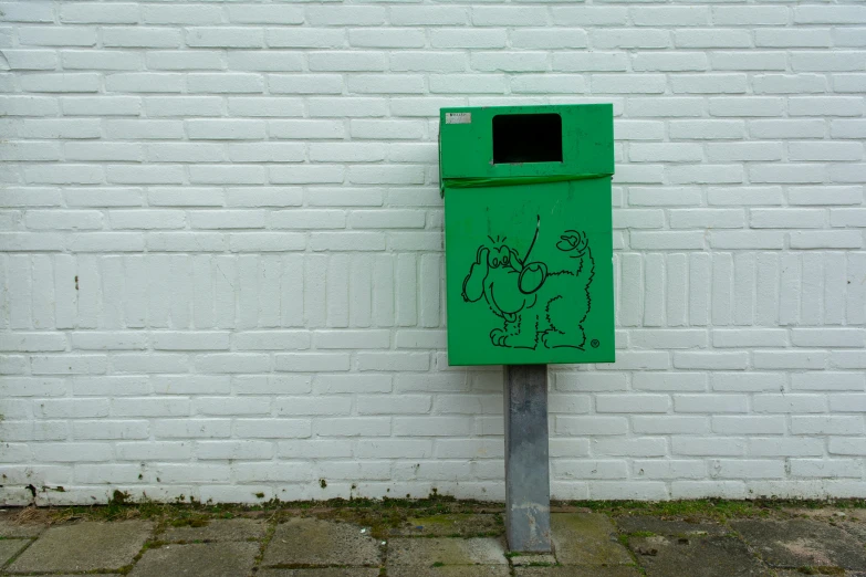 a green box with some graffiti painted on it