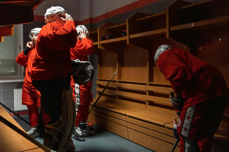 a man standing in the locker room talking on a cellphone