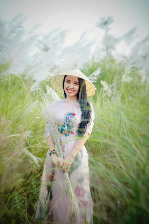 woman in a straw hat posing for a picture