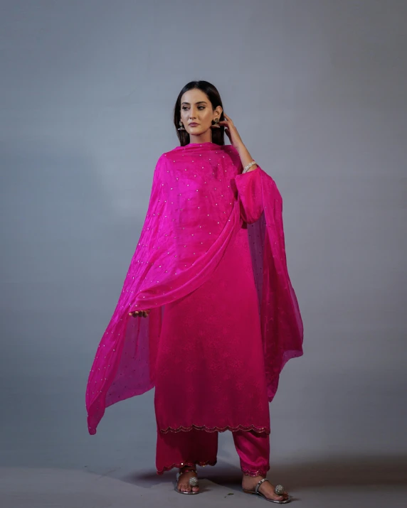 a woman in a pink suit and veil