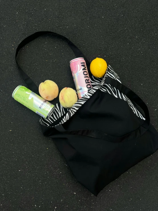 some soap bottles and a lime on top of a bag