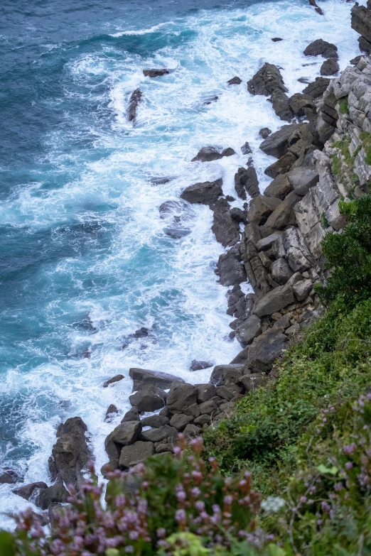 there is an ocean view with rocks and sea in the distance