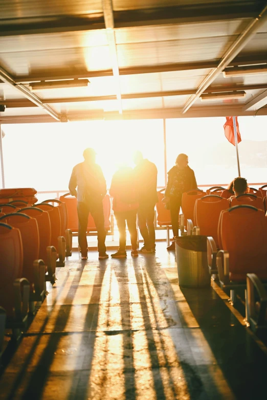 two people stand on a deck between chairs with suitcases