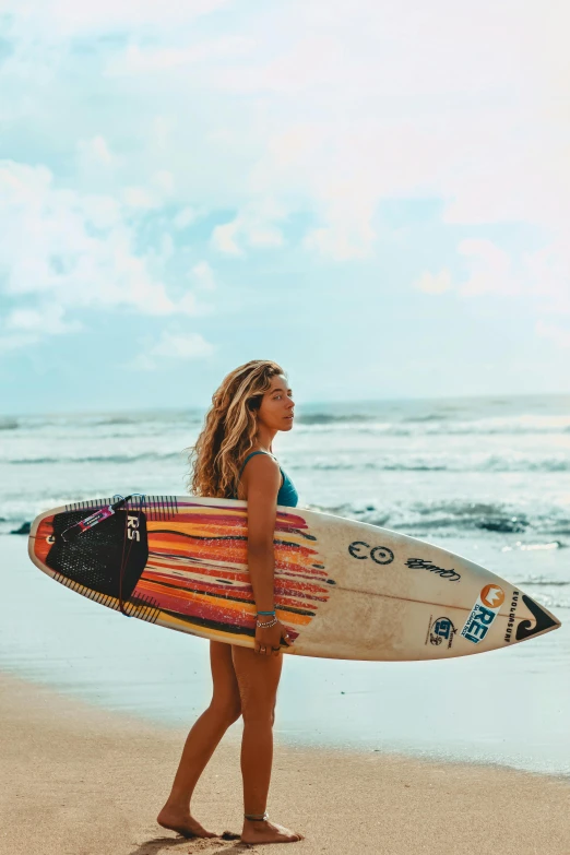 woman in bikini on the beach with surfboard