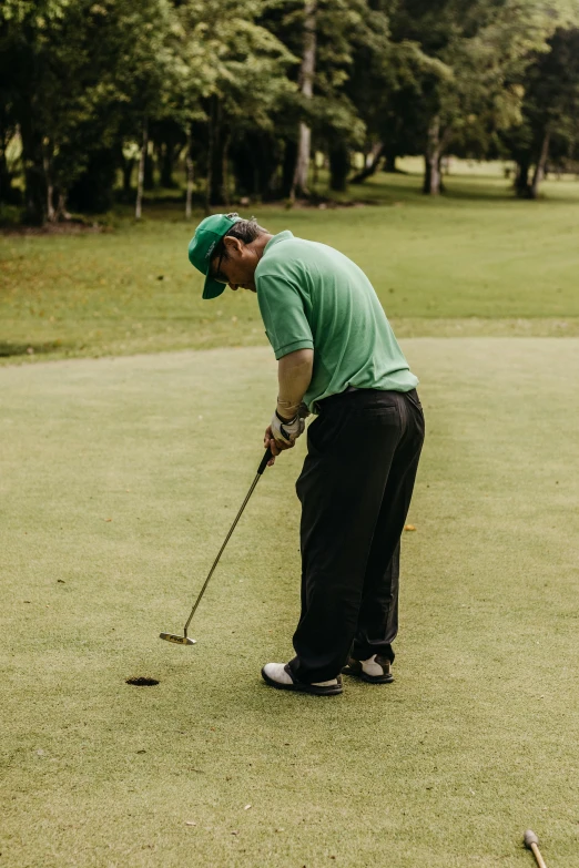 a man hitting a golf ball onto a green