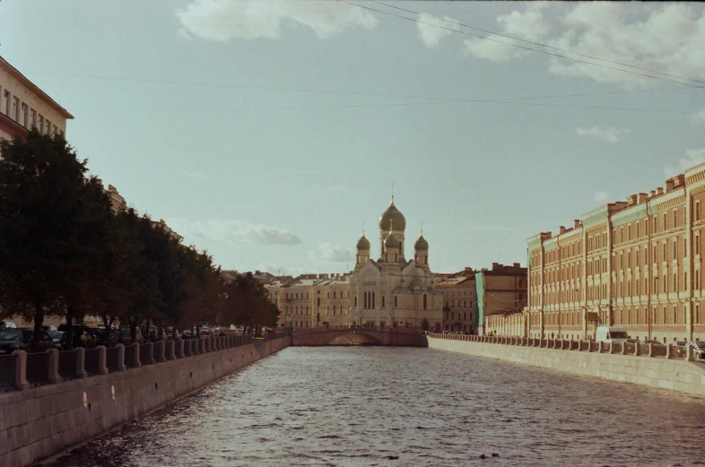 a large building sits along side of a river