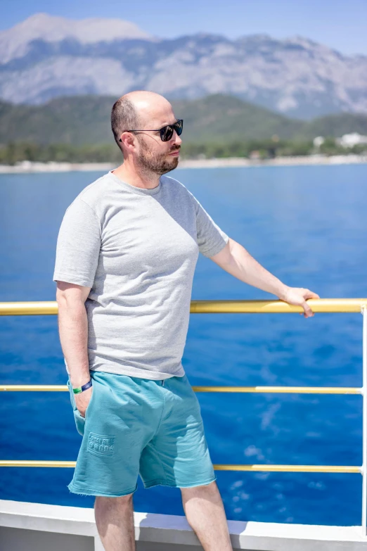 a man on a boat looks out over the water