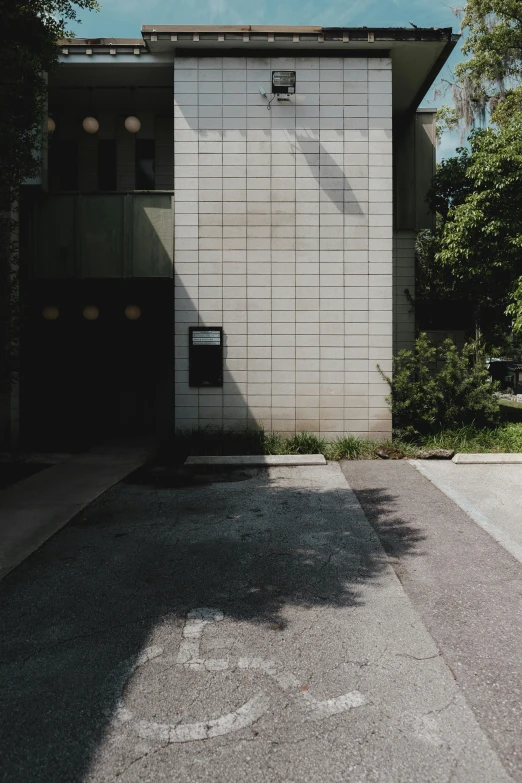 a shadow is cast on the road by a building