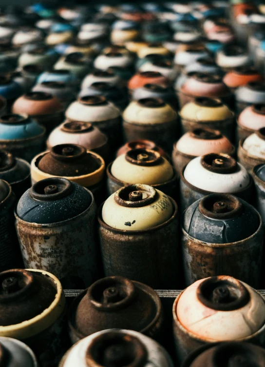 a bunch of old looking canisters lined up