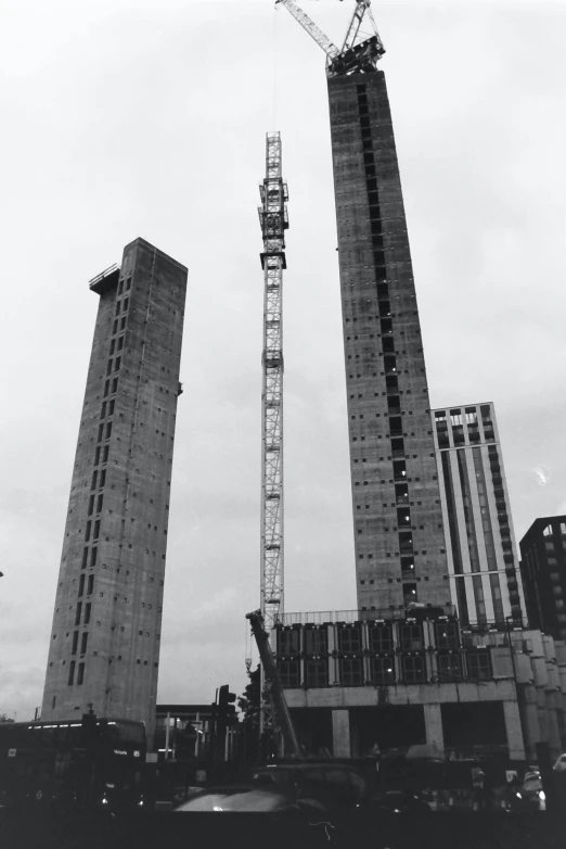 a large crane that is near two buildings