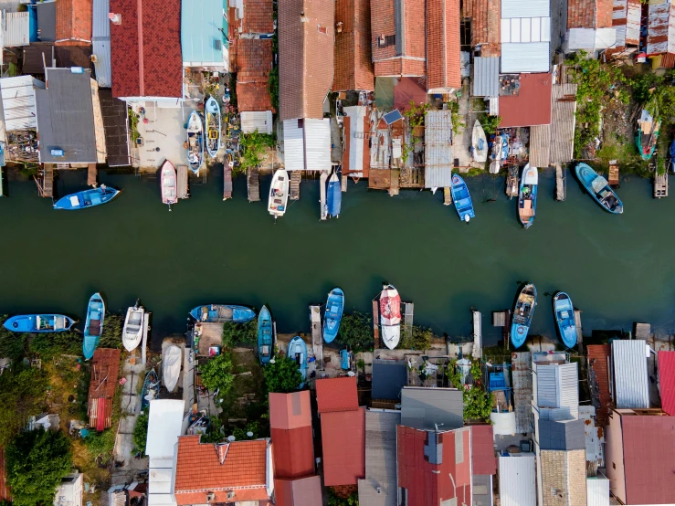 an aerial view of buildings with boats parked on them