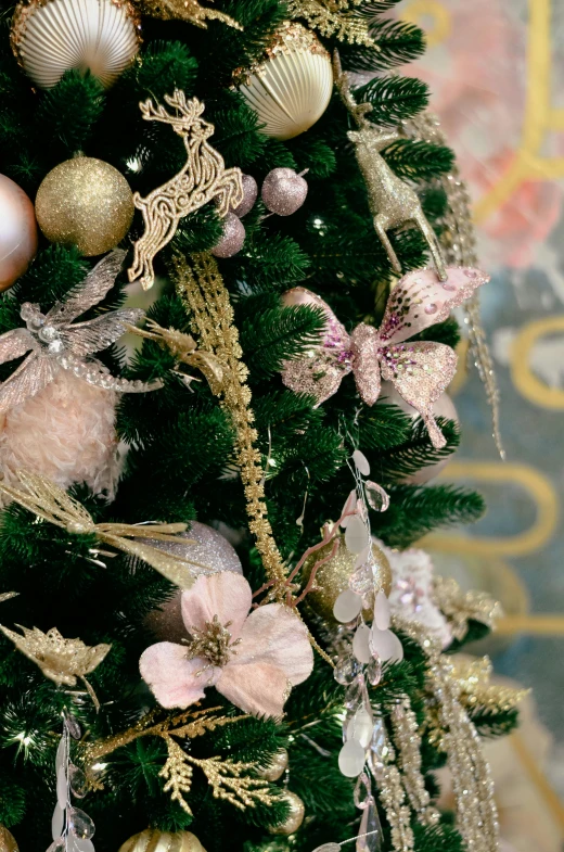 some shiny ornaments are on top of a small christmas tree